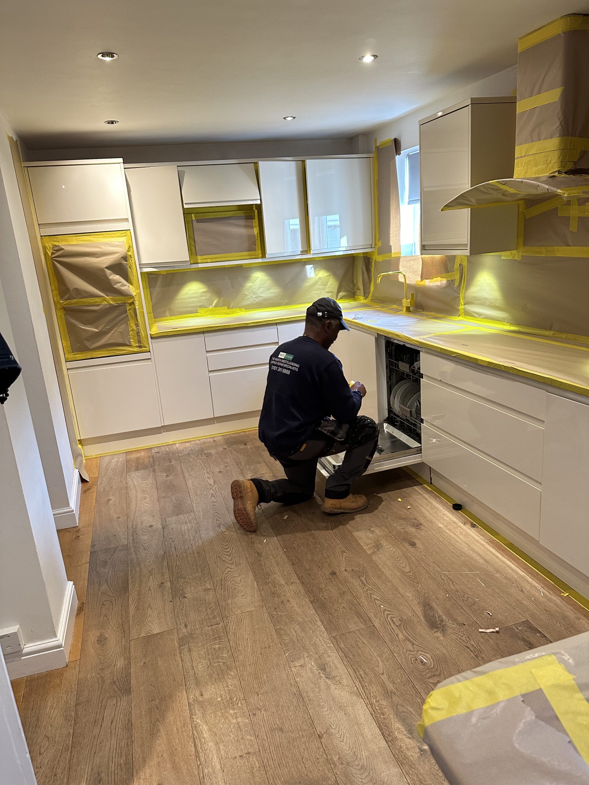 An image of a man on site doing Kitchen Respraying service